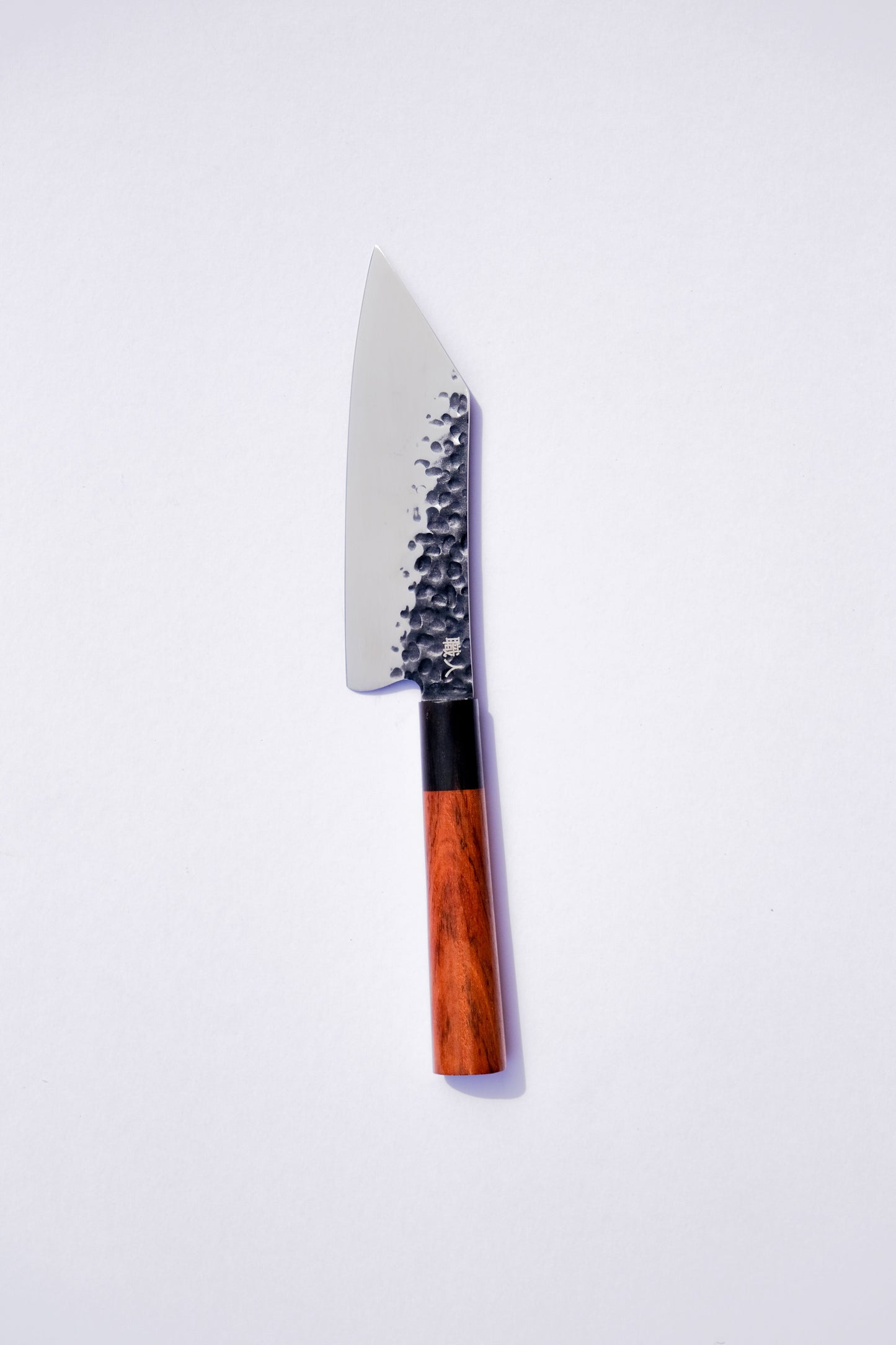 Serrated knife with a wooden handle on a white background