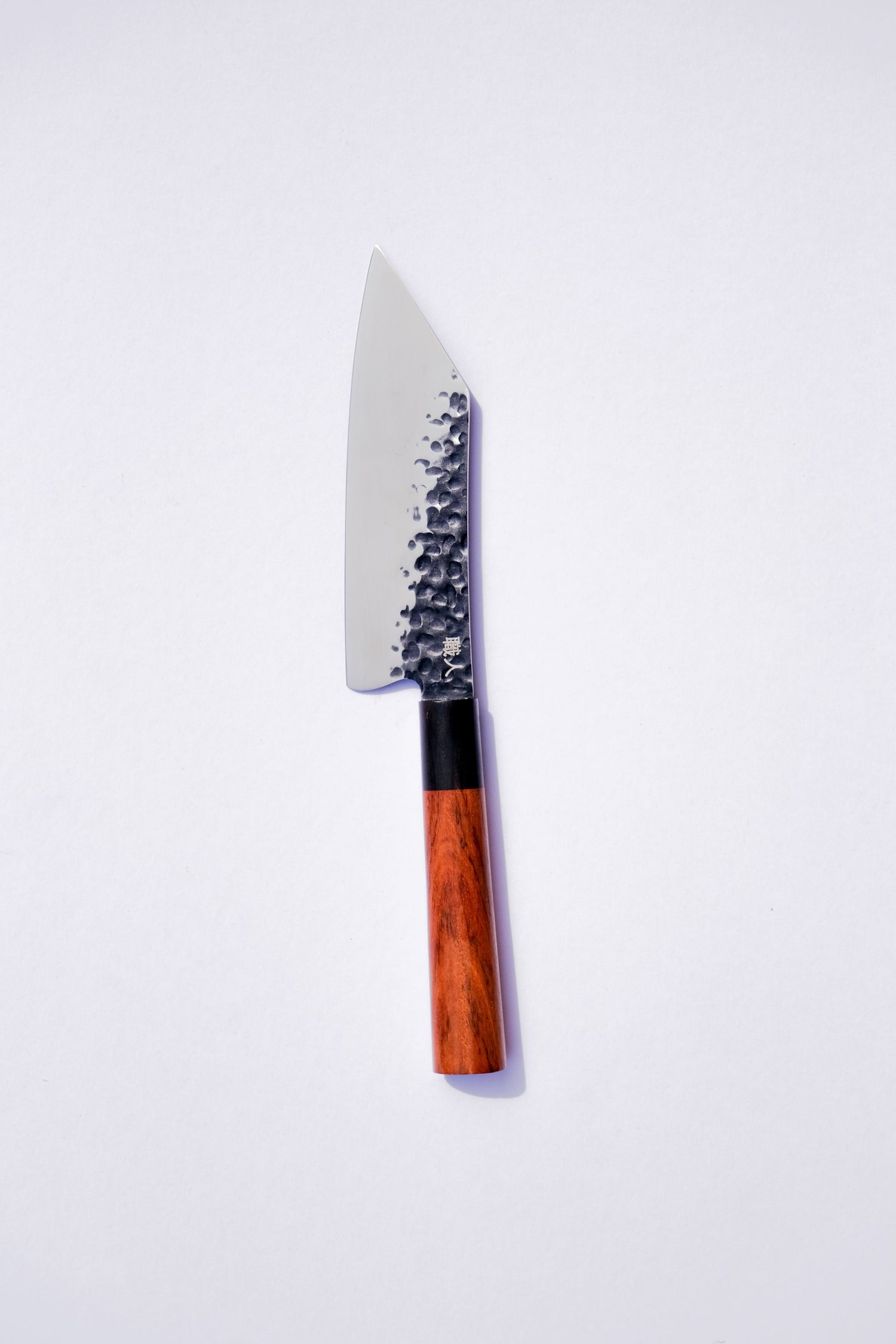 Serrated knife with a wooden handle on a white background